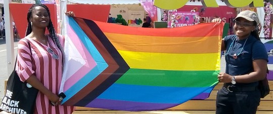 https://commons.wikimedia.org/wiki/File:Rainbow_flag_(%22Progress%22_variant_by_Daniel_Quasar)_at_EuroPride_2019_(Vienna).jpg
